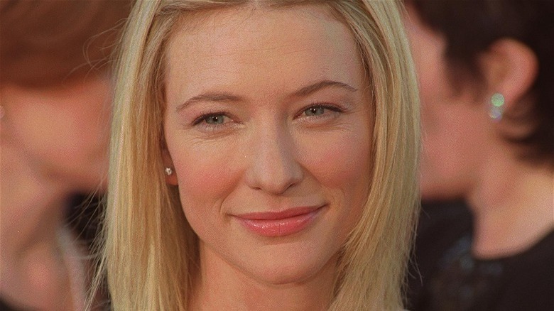A young Cate Blanchett smiling, blonde hair