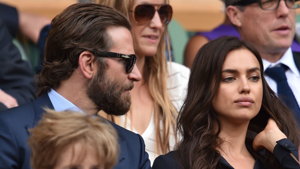 Bradley Cooper and Irina Shayk looking intense at a tennis match 