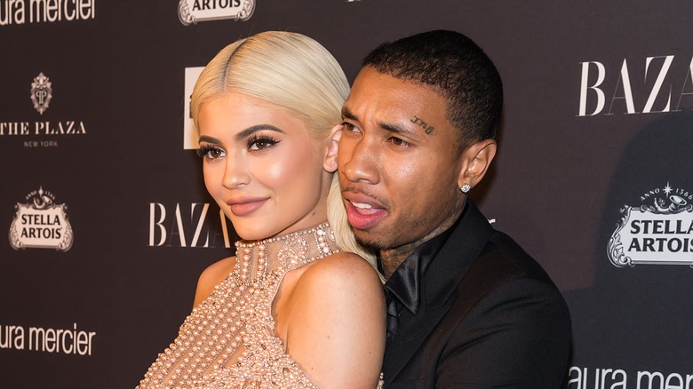 Kylie Jenner leaning against Tyga