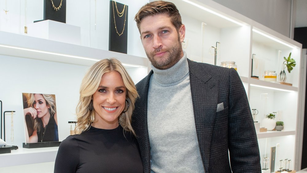 Kristin Cavallari and Jay Cutler, smiling while posing arm-in-arm at a store