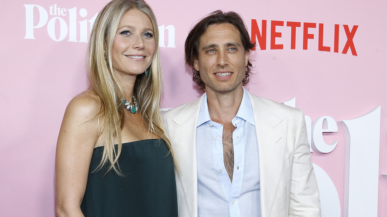 Gwyneth Paltrow and Brad Falchuk in front of a pink wall