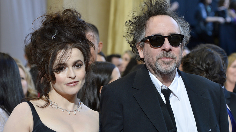 Helena Bonham Carter & Tim Burton at an event, both in black