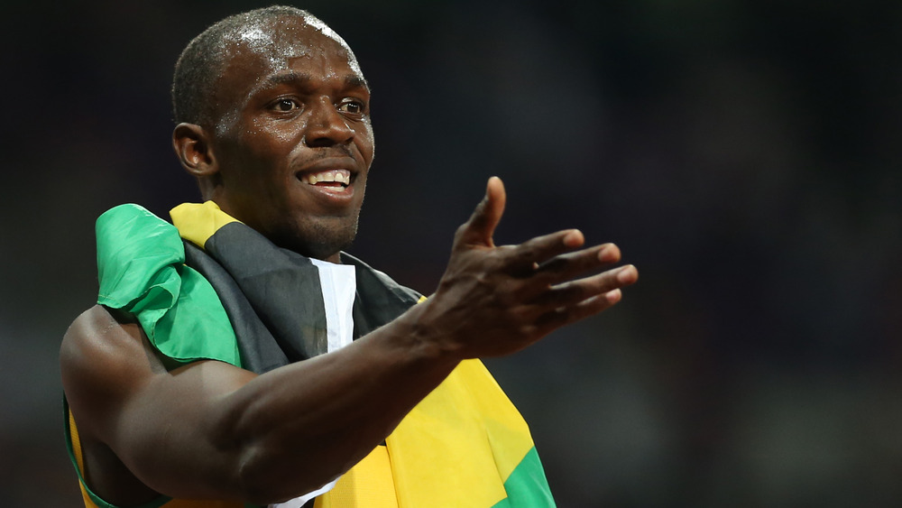 Usain Bolt wearing Jamaican flag