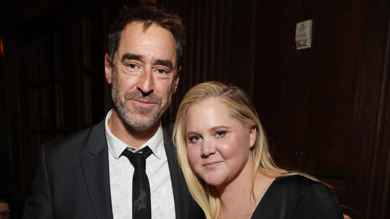 Amy Schumer and Chris Fischer posing in a photo