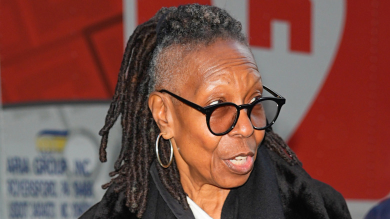 Whoopi Goldberg looks on