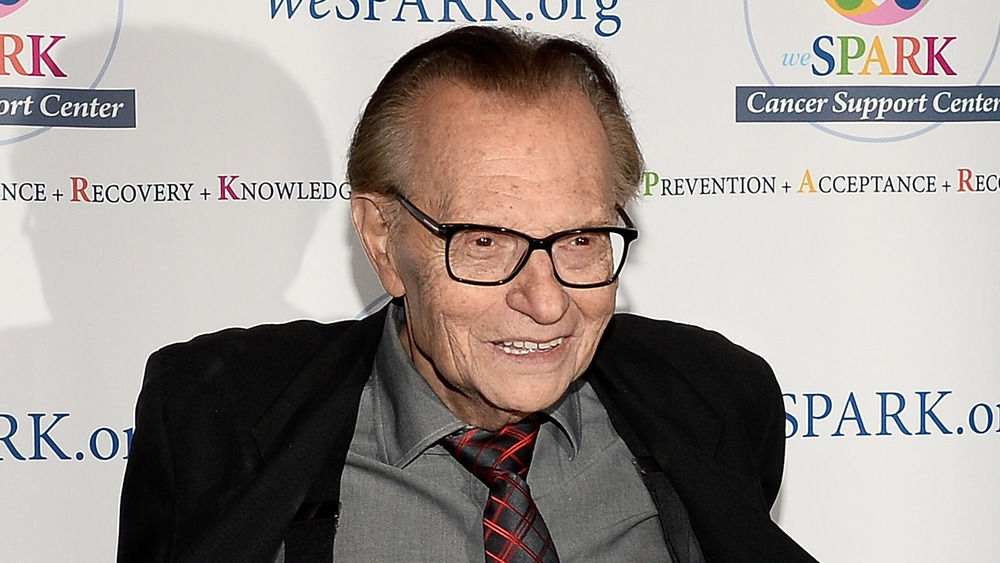 Larry King smiling in suit