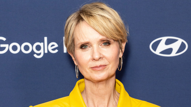 Cynthia Nixon smiling with hoops