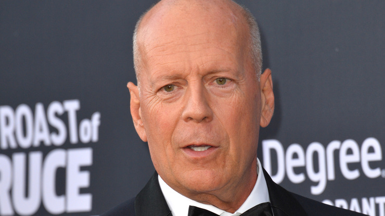 Bruce Willis staring ahead on the red carpet in 2018