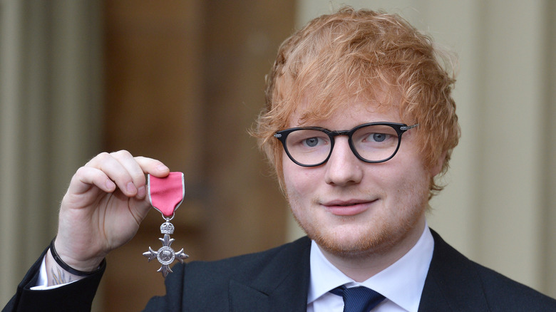 Ed Sheeran holding medal
