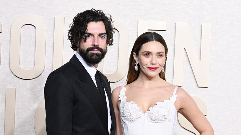 Elizabeth Olsen and Robbie Arnett pose in 2024