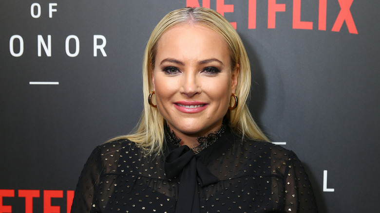 Megahn McCain wearing black louse and hoop earrings