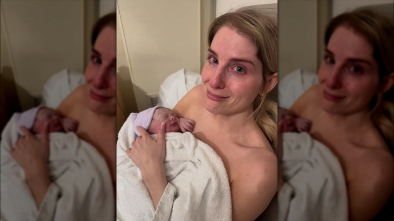 A visibly emotional Meghan Trainor holding her newborn daughter Mikey Moon Trainor.