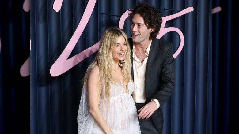 Pregnant Sienna Miller laughs with Oli Green