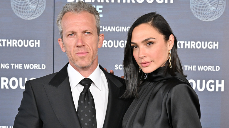 Gal Gadot and Jaron Varsano, both smirking
