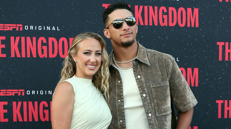 Patrick and Brittany Mahomes posing on the red carpet upon arrival for 