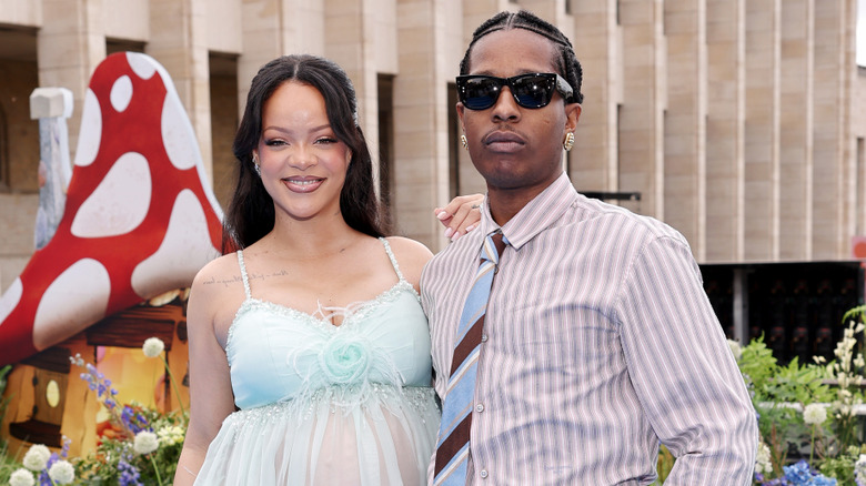 Rihanna smiling, posing with A$AP Rocky