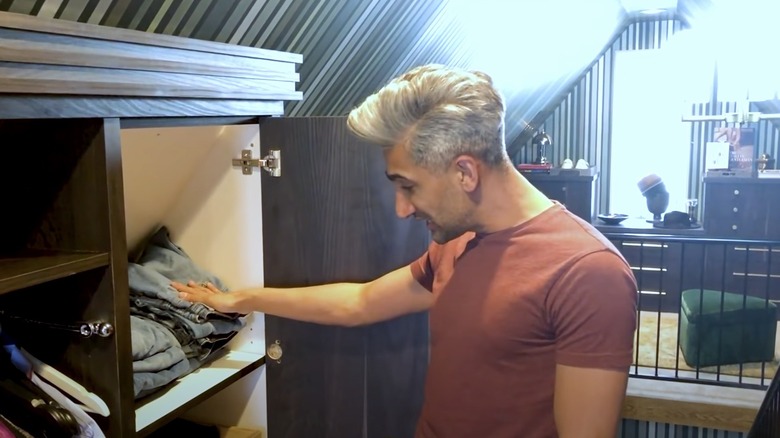 Tan France going through jeans in his closet