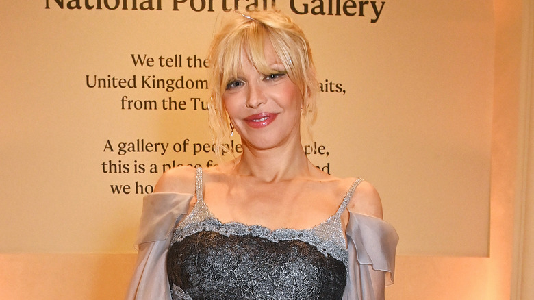 Courtney Love frilly dress smiling at National Portrait Gallery event
