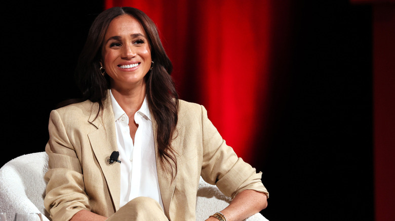 Meghan Markle smiles tan suit