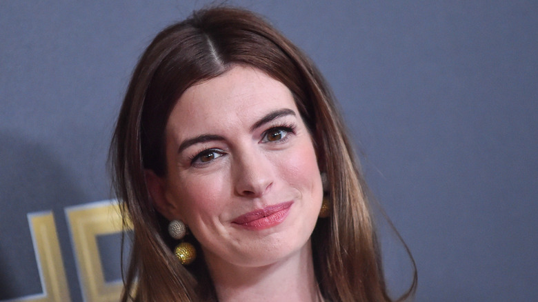 Anne Hathaway wearing a middle part, smiling