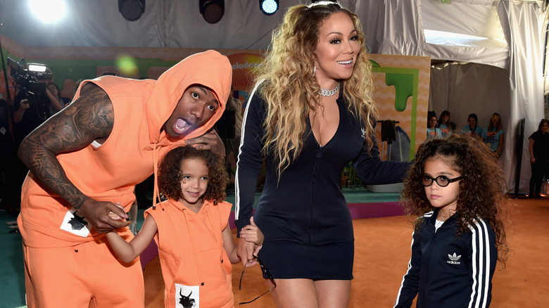 Nick Cannon and Mariah Carey with Monroe and Moroccan at an event