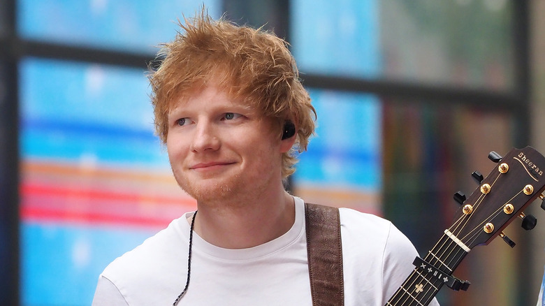 Ed Sheeran smiling with guitar
