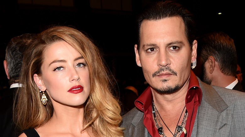 Amber Heard posing with Johnny Depp