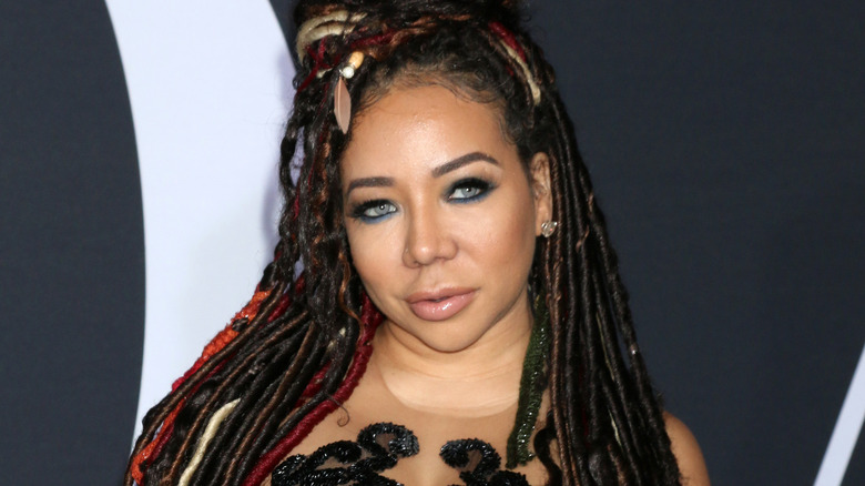 Tiny Harris smirking 