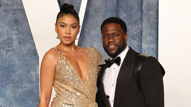 Kevin and Eniko Hart posing on a red carpet