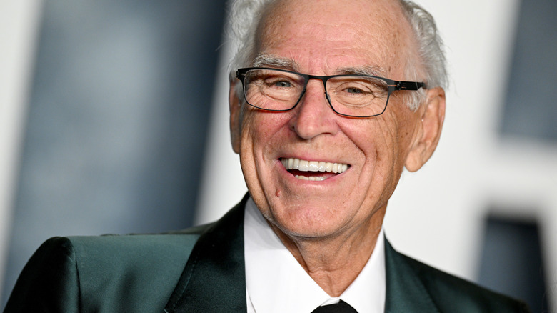 Jimmy Buffet smiling wearing glasses