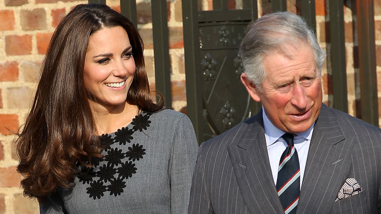 Kate Middleton smiling alongside King Charles