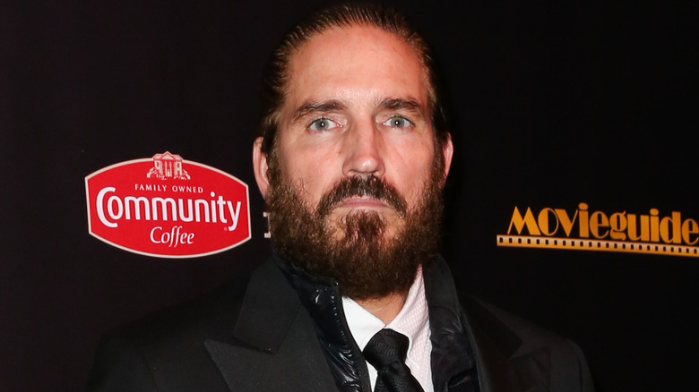 Jim Caviezel frowning at event
