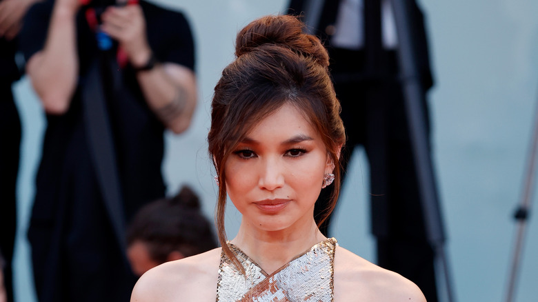 Gemma Chan in gold dress