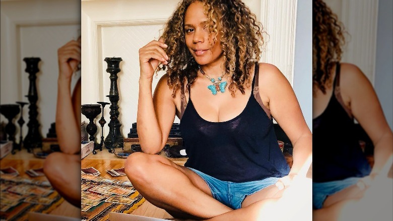 Rachel True sitting cross-legged