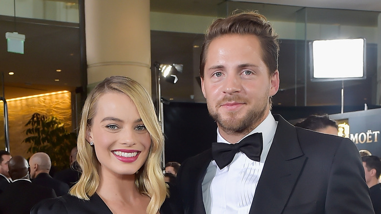Margot Robbie and Tom Ackerley smiling