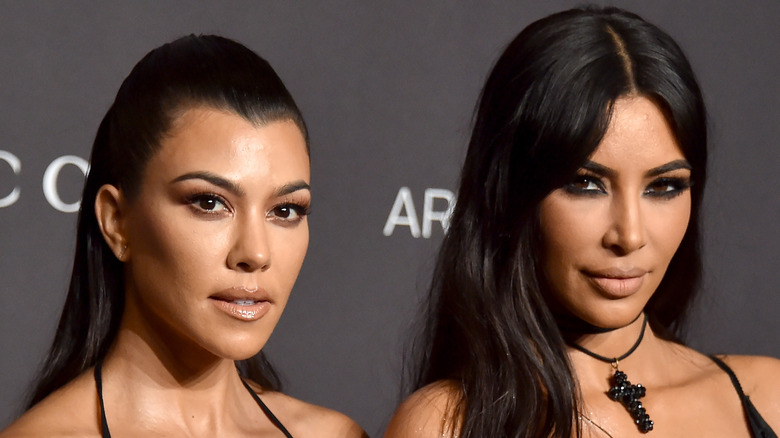 Kourtney and Mik Kardashian posing