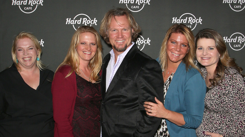 Kody Brown posing and smiling with his wives