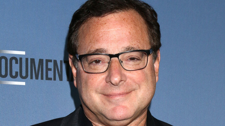 Bob Saget with glasses, smiling