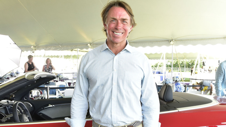 John Besh standing by car