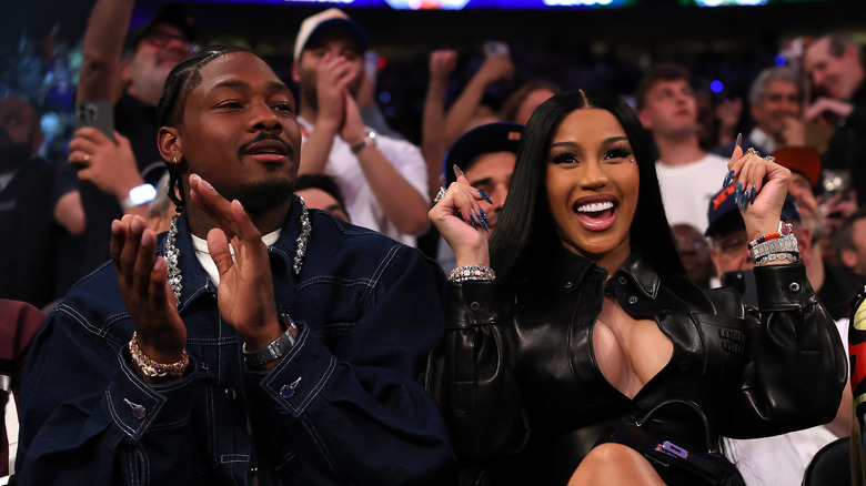 Stefon Diggs and Cardi B sitting courtside