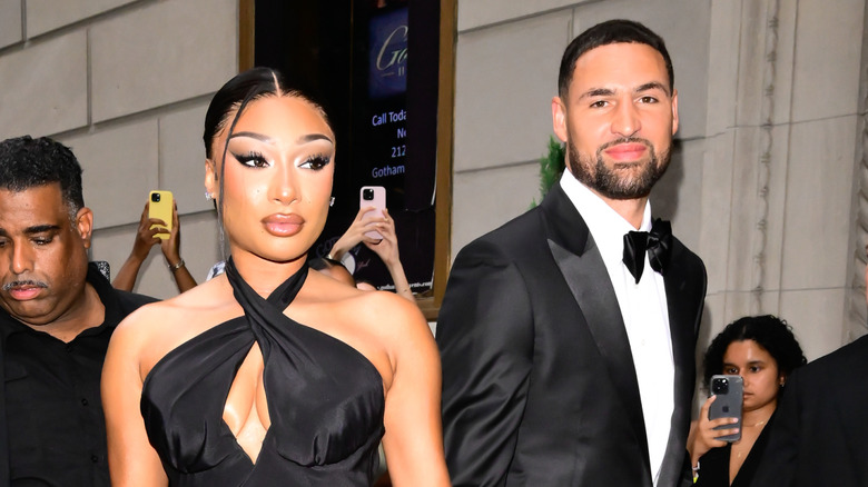 Megan Thee Stallion and Klay Thompson wearing formalwear