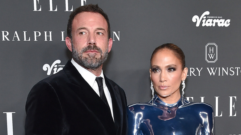Ben Affleck and Jennifer Lopez looking away from the camera with serious expressions