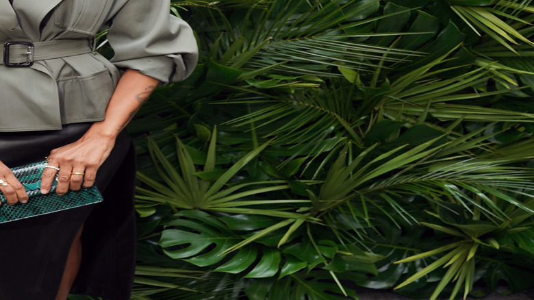 Zoe Saldaña in front of tropical trees