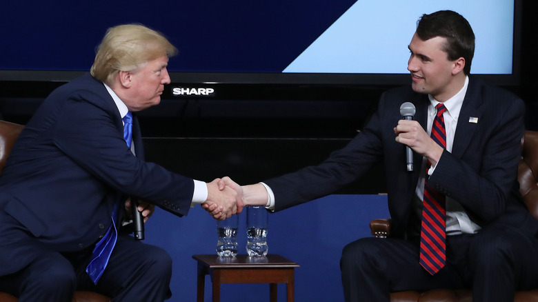 President Donald Trump shaking hands with conservative activist Charlie Kirk at a forum dubbed the Generation Next Summit at the White House