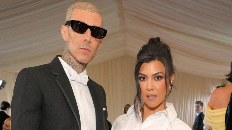Travis Barker and Kourtney Kardashian posing