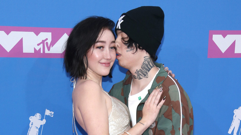 Noah Cyrus posing with ex Lil Xan, pushing his face into the side of her face