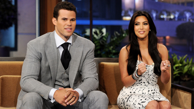 Kim Kardashian making fists beside Kris Humphries