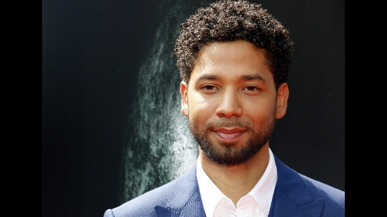 Jussie Smollett smiling in a suit