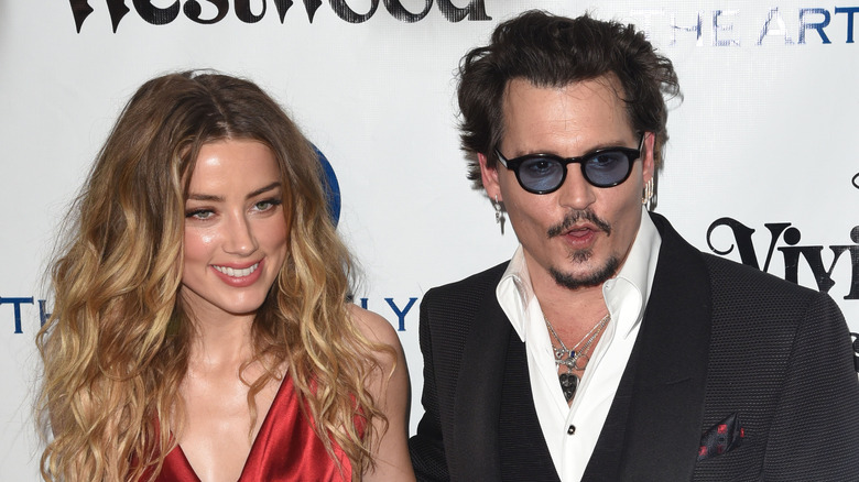 Amber Heard smiling with Johnny Depp
