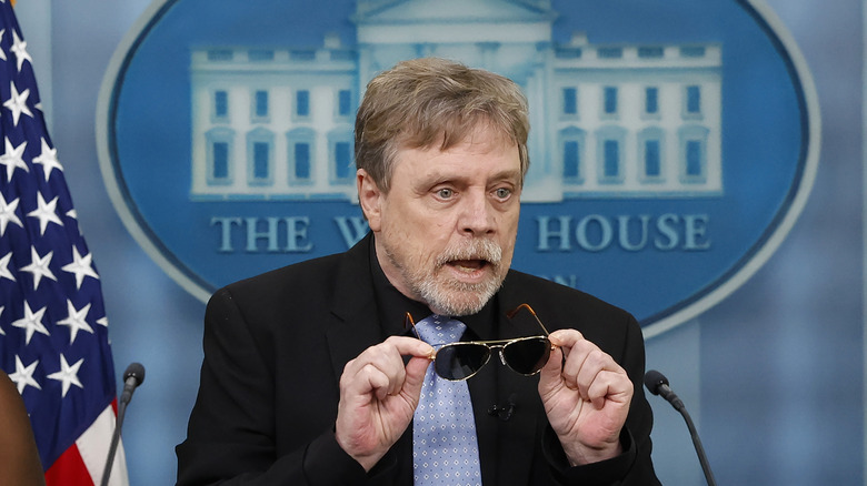 Mark Hamill holding sunglasses